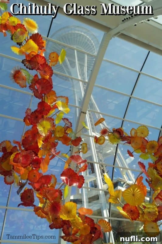 Chihuly Glass Museum over a glass flower display and the Space Needle behind it