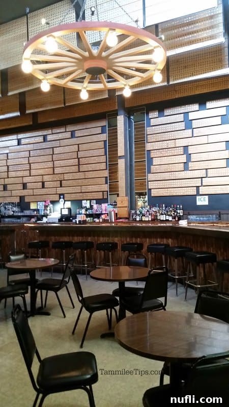 Cozy bar area at the 50,000 Silver Dollar Bar featuring tables, chairs, and walls adorned with countless silver dollars