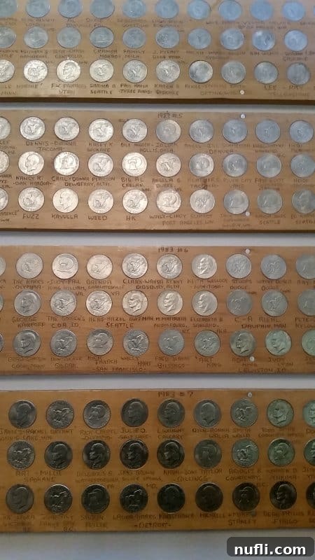 Detailed view of silver dollars meticulously arranged on display boards at the 50,000 Silver Dollar Bar, each with names and dates