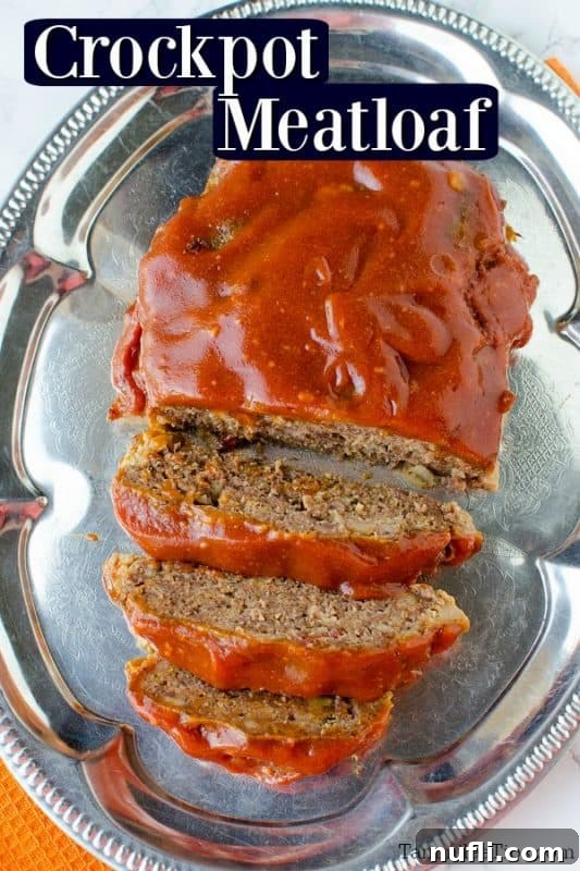 Effortless Slow Cooker Meatloaf 2 Delicious slices of crockpot meatloaf on a silver platter, topped with a rich glaze.