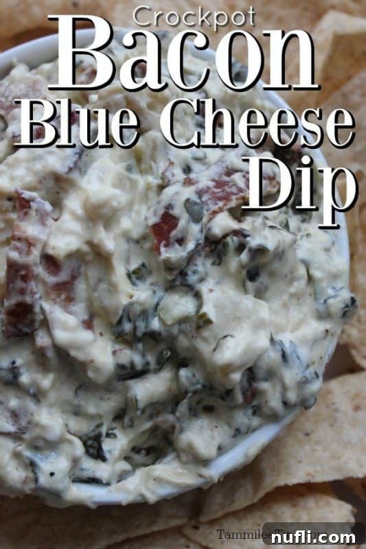 Creamy Crockpot bacon blue cheese dip served in a white bowl, surrounded by a generous spread of crispy tortilla chips, inviting guests to dig in.