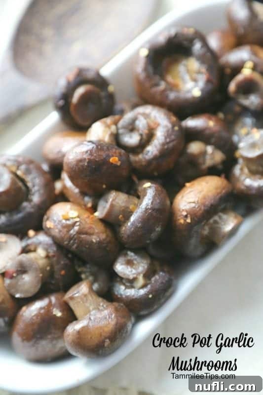 Easy Slow Cooker Mushrooms 3 Crockpot Garlic Mushrooms in text written below a white bowl filled with mushrooms
