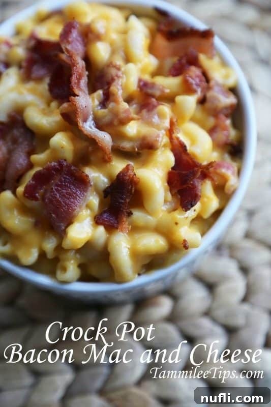 A delectable white bowl overflowing with creamy Crockpot Bacon Mac and Cheese, garnished with extra crispy bacon bits and fresh parsley.