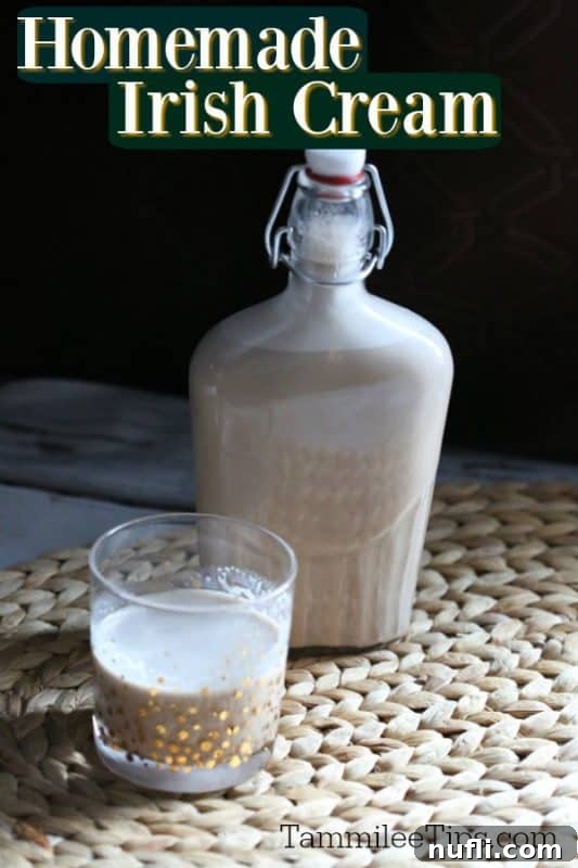 Homemade Irish Cream in a glass with a jar filled with Irish Cream in the background