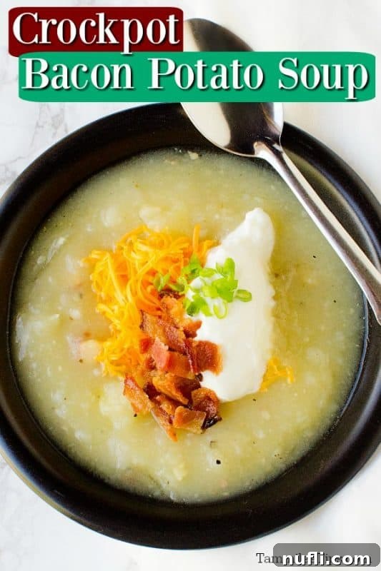 crockpot bacon potato soup over a dark bowl filled with soup