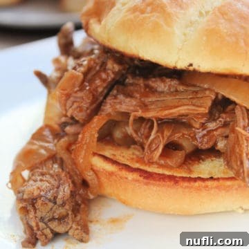 Bourbon Barbecue Pulled Beef Sandwiches 3 Crock Pot Bourbon Barbecue Beef Sandwich on a white plate