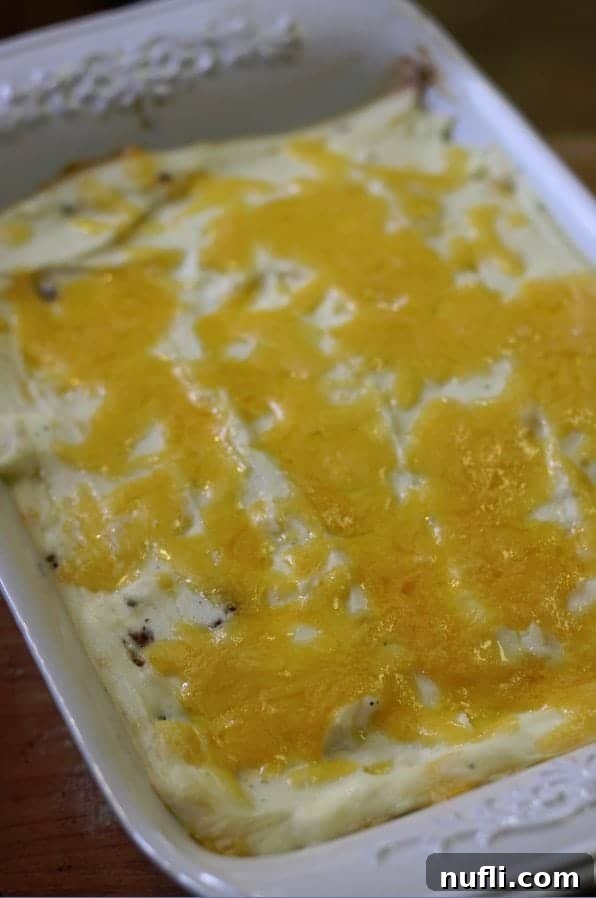 Super easy shepherd's pie freshly baked, golden brown and bubbling, just out of the oven in a white baking dish.