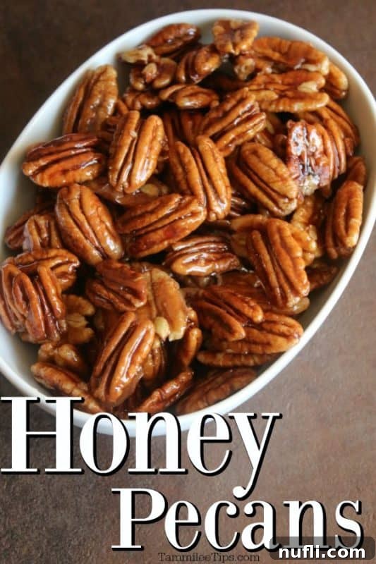 A close-up of delicious honey glazed pecans in a white ceramic bowl, ready to be enjoyed.