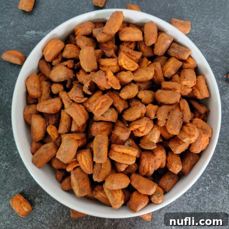 Effortless Entertaining: Simple Finger Foods for Any Party 6 Spicy Buffalo Pretzels piled high in a white bowl, coated in a zesty, reddish seasoning, ideal for a bold snack.