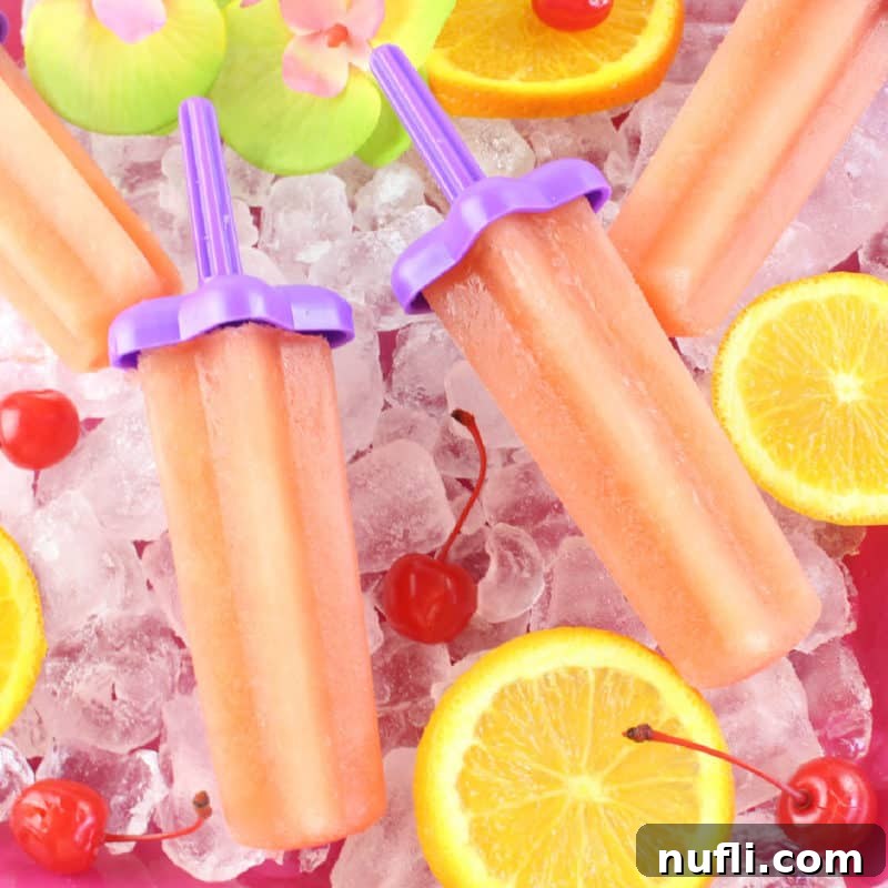 Sun-Kissed Sips: Over 35 Refreshing Summer Cocktails 29 Bahama Mama Popsicles on a bed of ice with orange slices and maraschino cherries
