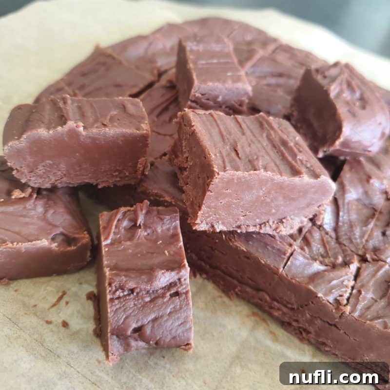 Famous Carnation Fudge squares stacked neatly on parchment paper