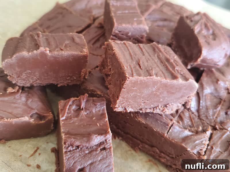 Individual pieces of Carnation Famous Fudge on parchment paper, ready to serve
