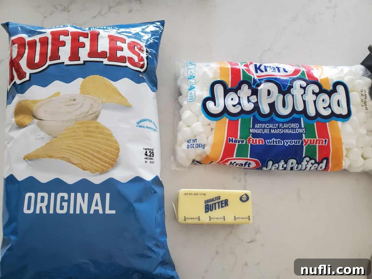 Ingredients for Ruffles Marshmallow Treats: a bag of Ruffles Original Potato Chips, a stick of butter, and a bag of mini marshmallows on a white counter.