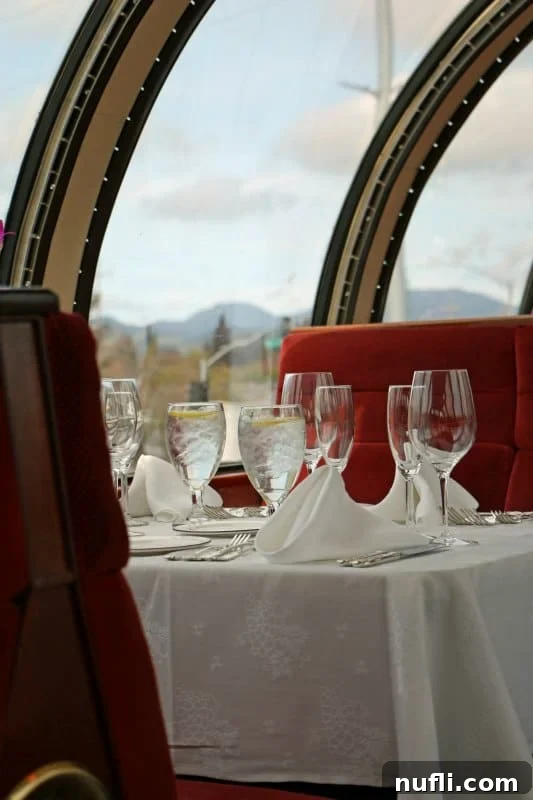 dome train with tables set with wine glasses