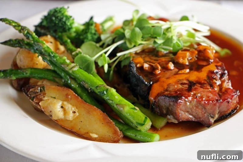 Steak and asparagus on a white plate