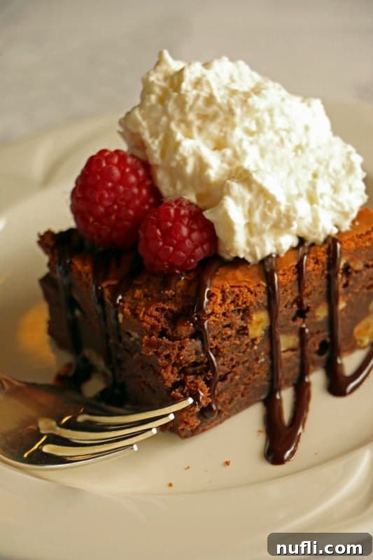 Chocolate dessert with raspberries and whipped cream