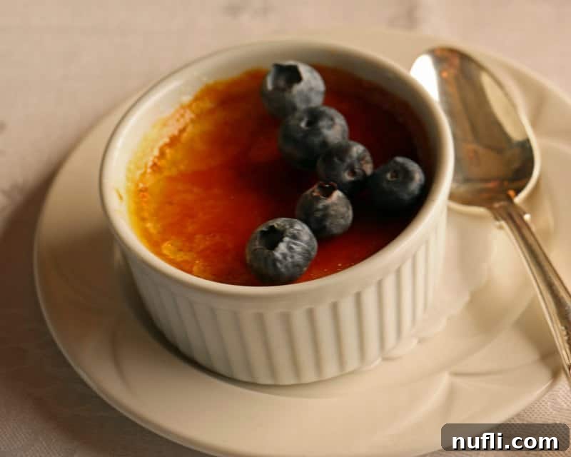 Napa Valley Wine Train Experiences 10 Rich creme brulee in a ramekin, garnished with fresh blueberries