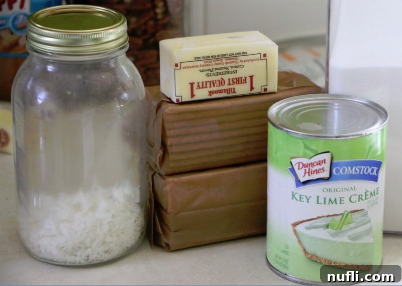 Ridiculously Easy Key Lime Bars 3 Key lime pie filling, graham crackers, butter, and shredded coconut laid out on a kitchen counter, prepared for baking.