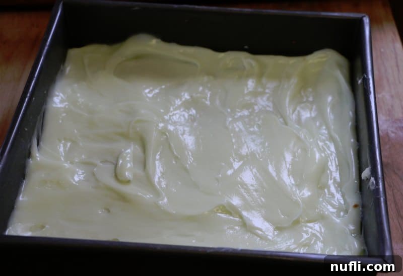 Ridiculously Easy Key Lime Bars 5 Key Lime Pie Bars with a creamy green filling and a graham cracker crust set in a baking dish.