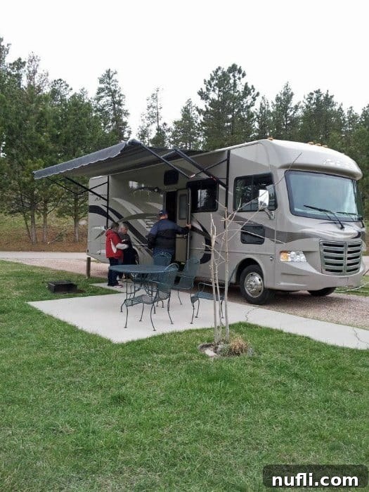 A large RV perfectly parked in a spacious campsite at Mount Rushmore KOA, showcasing easy access and ample room