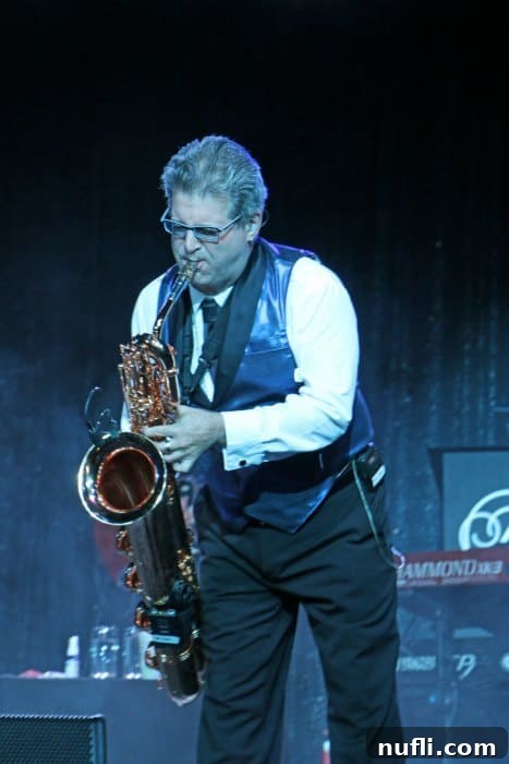 Saxophone player performing on stage with dynamic lighting
