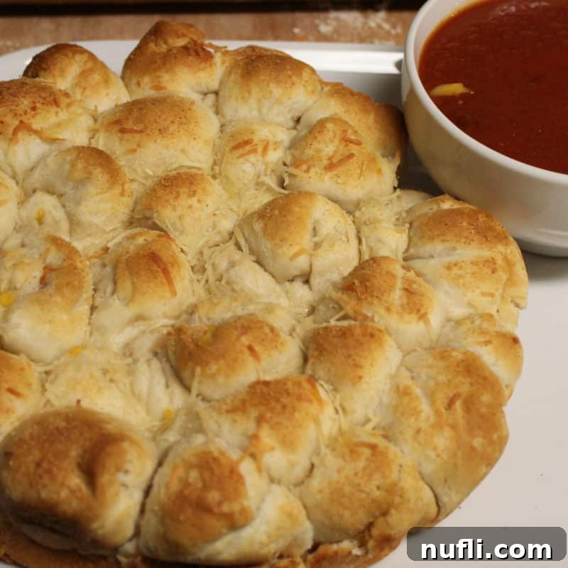 Cheesy Biscuit Bites next to a bowl of marinara sauce
