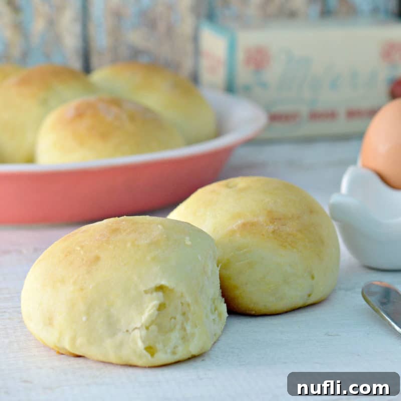sweet bread rolls next to a bread knife and eggs