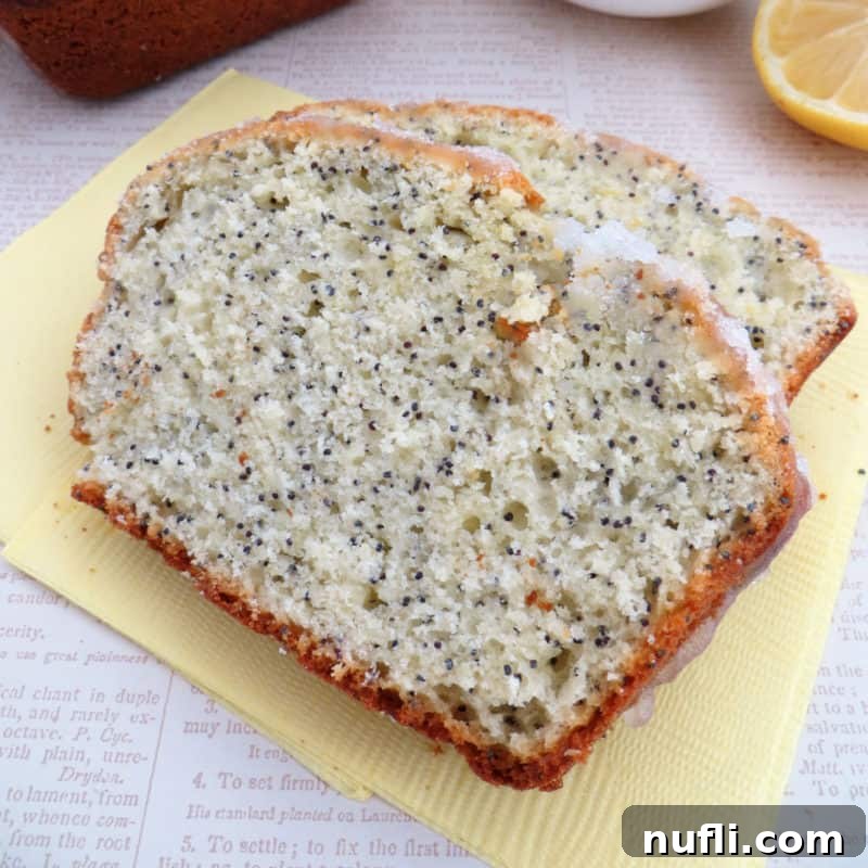 Two slices of lemon poppy seed bread on a yellow napkin