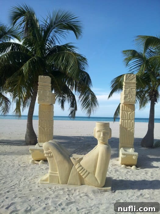 Passion Island Cozumel Power Catamaran Adventure 4 Whimsical sand sculptures depicting marine life nestled beneath swaying palm trees on Passion Island's beach