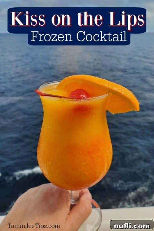 Kiss on the Lips Frozen Cocktail text over a hand holding a tropical drink with a cherry and orange wedge with the ocean in the background. 