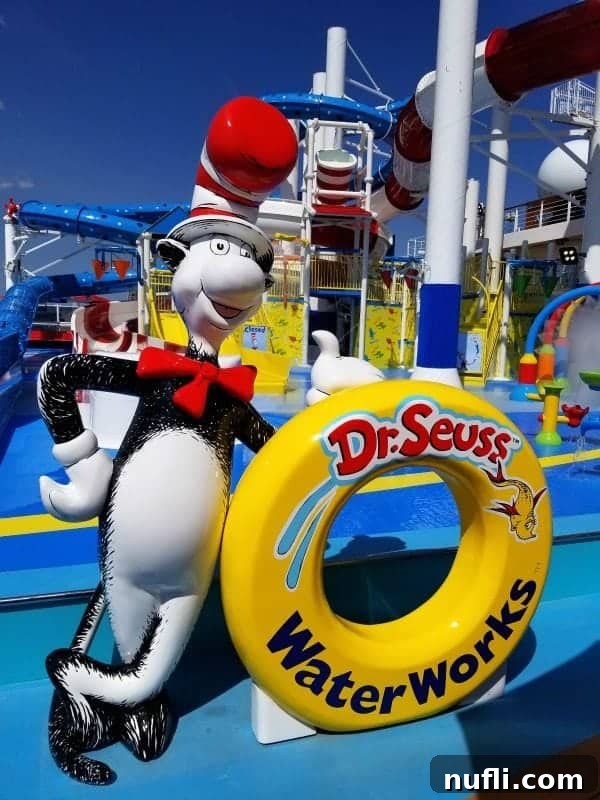 A vibrant Dr. Seuss Waterworks sign against a backdrop of colorful waterslides, promising aquatic fun