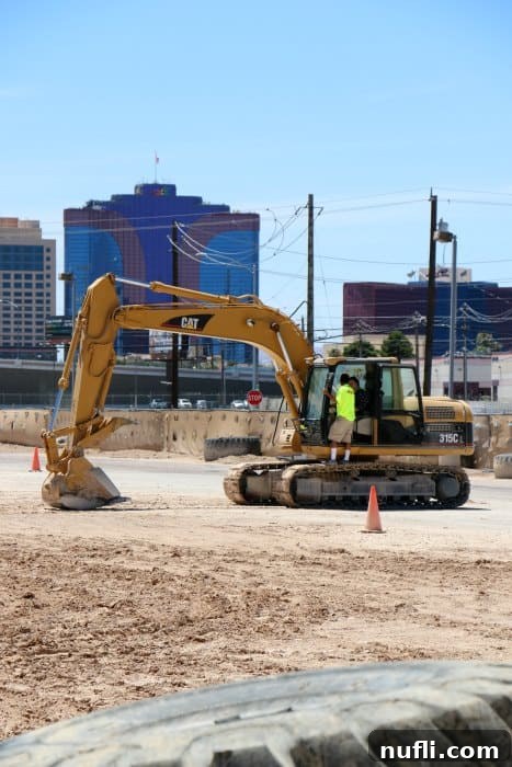 Tammilee in an excavator with the Vegas strip behind it 