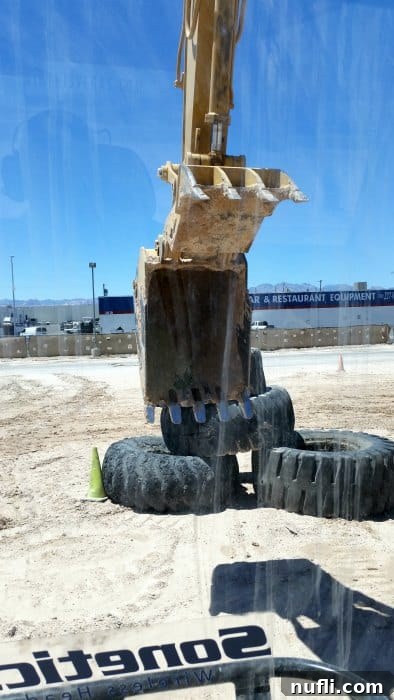 Looking out from an excavator to a stack of tires