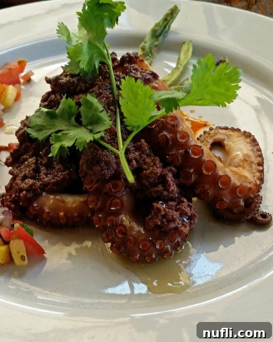 Charred octopus on a white plate