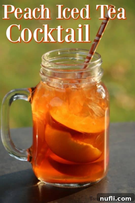 A refreshing Peach Iced Tea Cocktail served in a tall glass with fresh peach slices and ice.