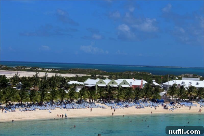 View of Grand Turk's white sand beach and turquoise water from a cruise ship, highlighting the proximity and beauty of the port.