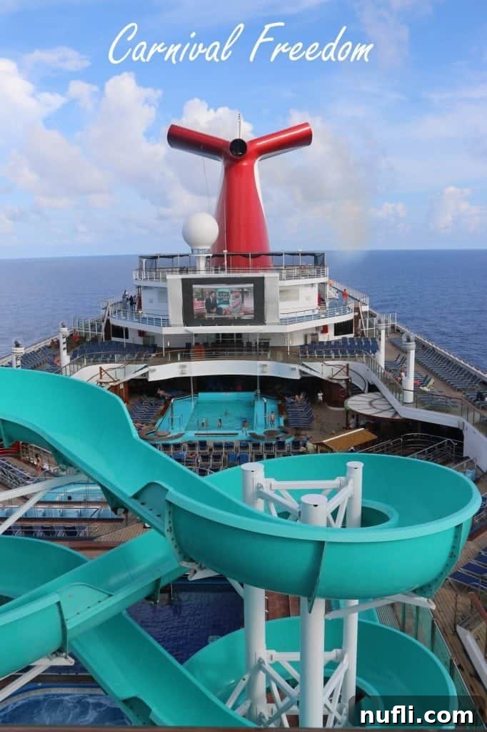Carnival Freedom text overlay on an image of the Lido deck with waterslides, pool, and the distinctive red and white Carnival funnel