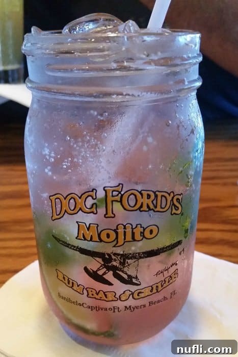 A chilled glass with a Doc Ford's Mojito Rum Bar & Grille logo