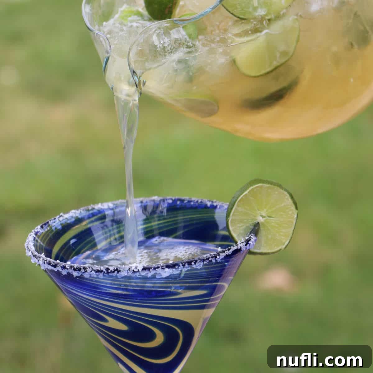 Whip Up Delicious Beer Margaritas 5 Beer Margaritas pouring from a glass pitcher into a margarita glass