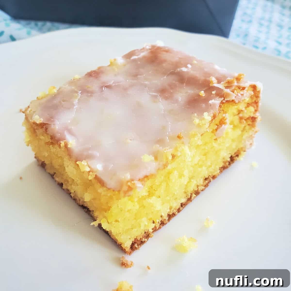 Square of Lemon Jello Cake on a white plate