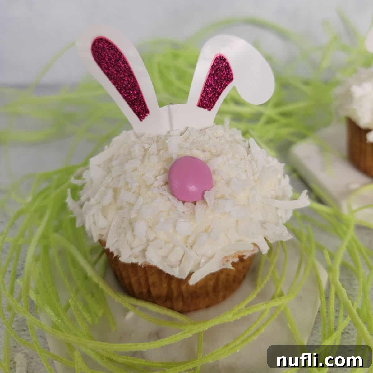 Easy Bunny Cupcake surrounded by green edible grass