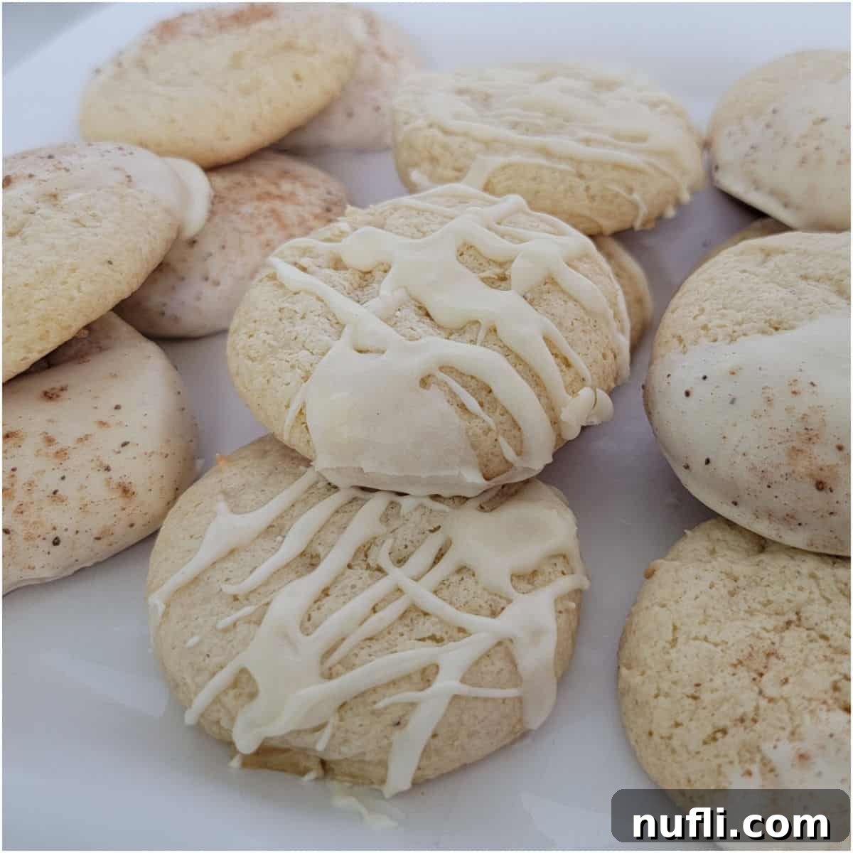 Eggnog cake mix cookies with icing on a white plate