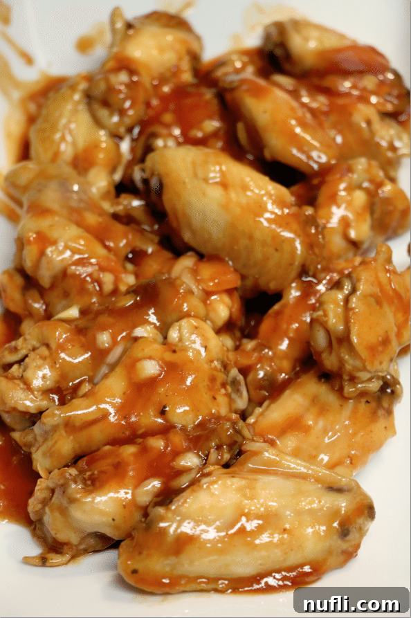 A generous platter of golden-brown Honey Sriracha Barbecue Chicken Wings, ready to be served.