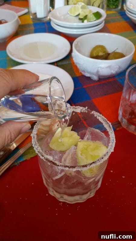 shot glass pouring into a cup 