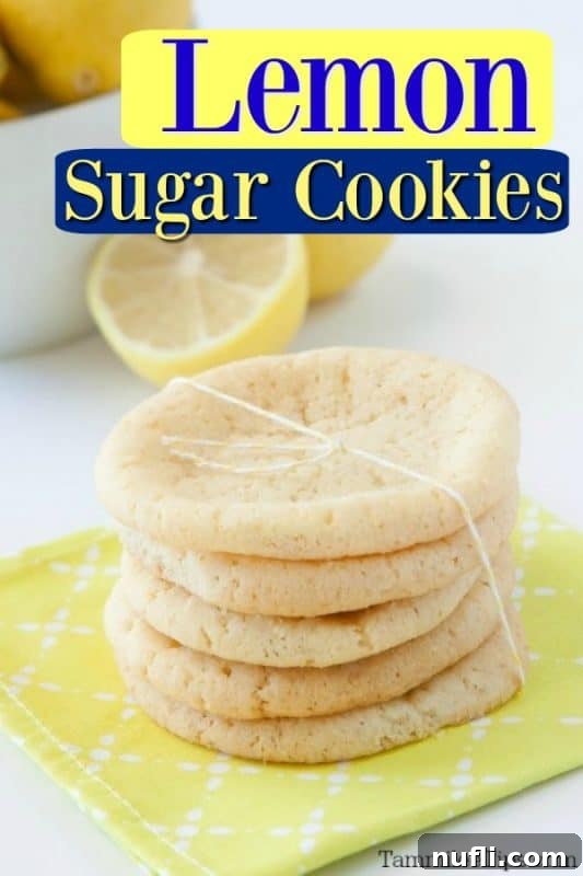 Delightful Lemon Sugar Cookies stacked on a yellow napkin with fresh lemons in the background