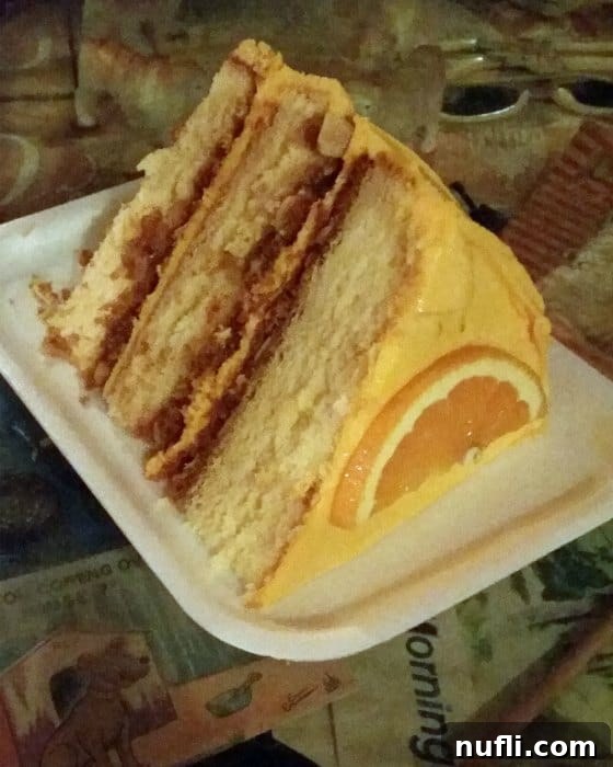 The Bubble Room Captiva Island Where Whimsy Meets Florida Charm 5 An enormous, decadent slice of The Bubble Room's famous Orange Crunch Cake, showcasing its impressive size and tempting layers.