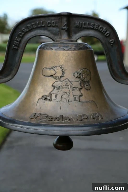 The iconic, weathered school bell of L'Ecole No. 41 winery stands as a proud symbol of its rich past as a historic schoolhouse in the heart of Walla Walla.