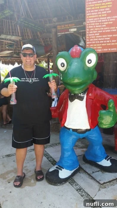 John at Senor Frogs holding two glasses