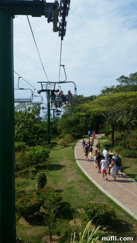 Mahogany Bay Roatan Cruise Haven 3 Ski lift over tropical plants and people walking on a walkway