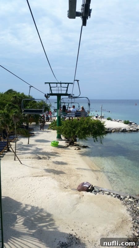 Mahogany Bay Roatan Cruise Haven 7 Ski lift with people riding over the beach